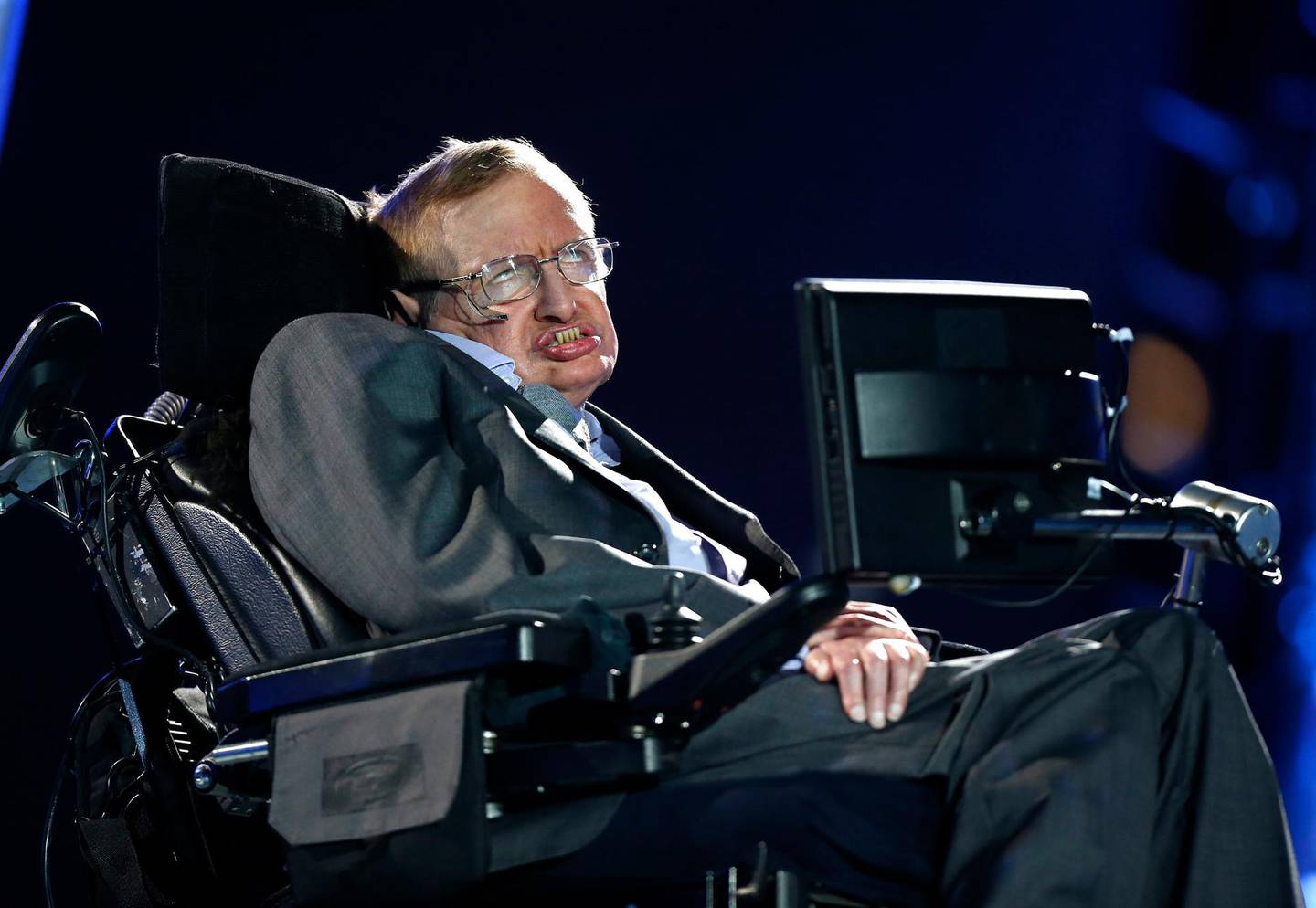 FILE - In this Aug. 29, 2012 file photo, British physicist, Professor Stephen Hawking during the Opening Ceremony for the 2012 Paralympics in London.  Hawking will take his place among Britain's greatest scientists when his ashes are buried in Westminster Abbey, Friday June 15, 2018, between the graves of Charles Darwin and Isaac Newton, during a service of thanksgiving for the physicist who died in March 2018. (AP Photo/Matt Dunham, File)