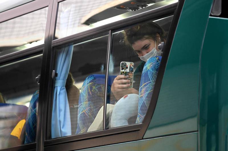 A member of the Australian softball national team takes a picture from a limousine bus upon arriving at a hotel in Ota City, Gunma prefecture. AFP