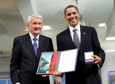 Nobel Peace Prize laureate, US President Barack Obama poses with his diploma and medal next to the Chairman of the Norwegian Nobel Committee, Thorbjoern Jagland (L) during the Nobel Peace prize award ceremony at the City Hall in Oslo on December 10, 2009. The president faces a tricky task of reconciling the revered honor with his decision just last week to send 30,000 troops to escalate the war in Afghanistan, a move which tripled the US force there since he took office.  AFP PHOTO / SCANPIX NORWAY / STR (Photo by STR / SCANPIX NORWAY / AFP)