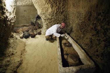 An archaeologist works on a mummy at the Tuna El-Gebel archaeological site in Minya, Egypt. EPA