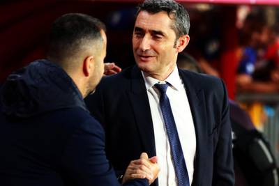 Granada's head coach Diego Martinez greets Barcelona's head coach Ernesto Valverde. EPA