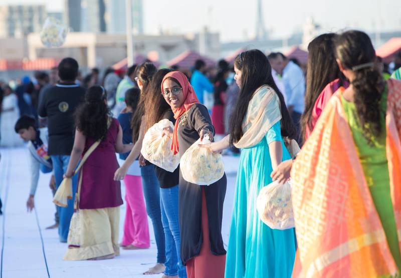 Dubai, United Arab Emirates- Volunteers arranging flower to be laid at the worlds largest fresh flower carpet with the theme of Tolerance to highlight UAE as a global capital  for tolerance at Dubai Festival City.  Leslie Pableo for The National