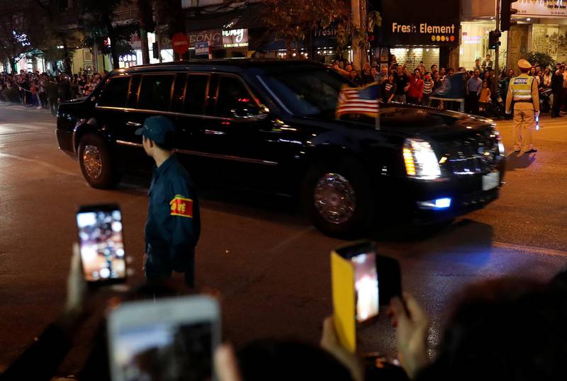 The motorcade of Donald Trump passes bystanders on a road near the Metropole Hotel. Reuters