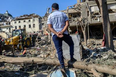 A man watches rescuers searching for victims or survivors at a blast site in the city of Ganja. AFP