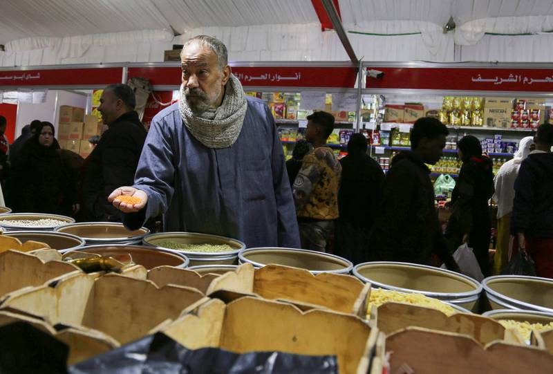 A shopper buys lentils at a food market in Cairo, Egypt. Reuters