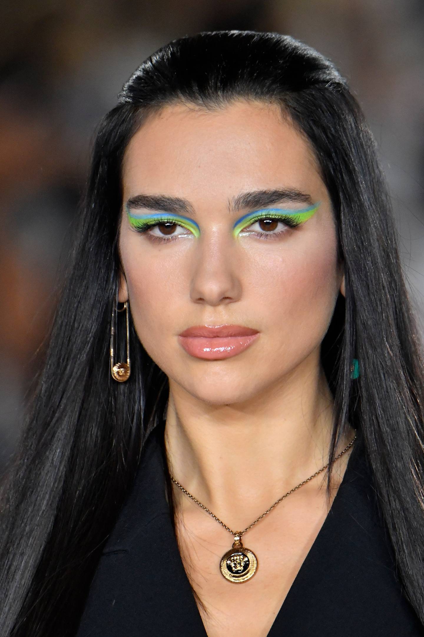 Dua Lipa on the Versace catwalk in brightly coloured eyeliner. Photo Versace