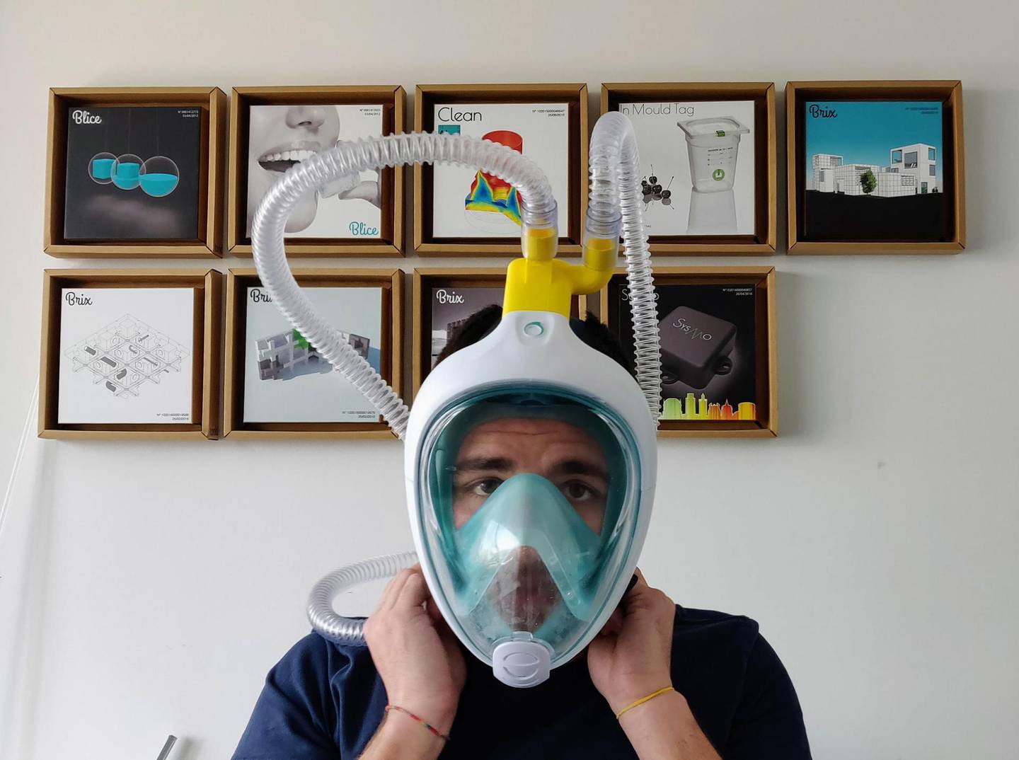 epa08315316 Engineer Alessandro Romaioli wears a diving mask modified with a respiratory valve that makes it a respiratory mask and produced by the start up Isinnova that is based in Brescia, Italy, 23 March 2020. The piece manufactured is a venturi valve made in 3-D printing method which is attached to a tube and connected to a mask. Isinnova told a local hospital that was running out of supplies while treating Coronavirus patients in Chiari they could have the valves that cost some three euros to manufacture for free. The company is already in talks with another hospital for a similar delivery, and can manufacture some 100 valves daily.  EPA/FILIPPO VENEZIA