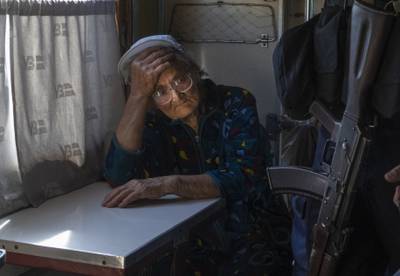 A woman evacuated from an area of conflict in June 2022 contemplates what the next move might be. AP