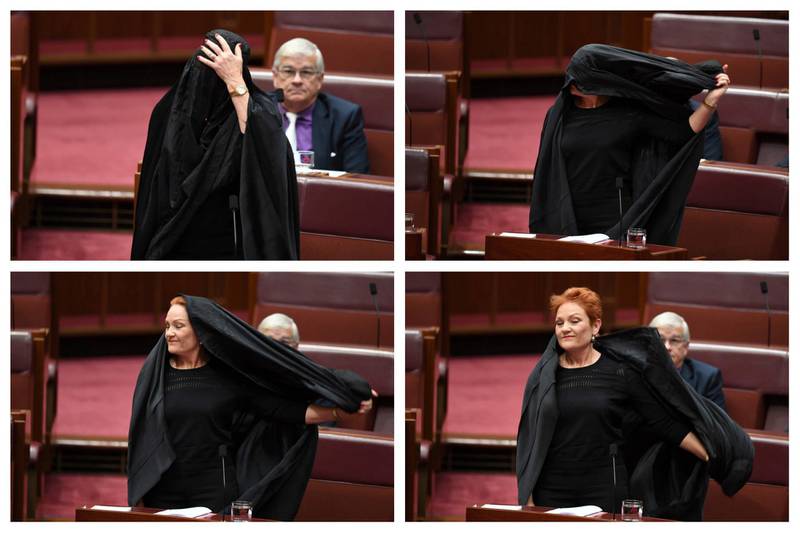 In this combination of photos Sen. Pauline Hanson takes off a burqa she wore into the Senate chamber at Parliament House in Canberra, Australia, Thursday, Aug. 17, 2017. Hanson, leader of the anti-Muslim, anti-immigration One Nation minor party, sat wearing the black head-to-ankle garment for more than 10 minutes before taking it off as she rose to explain that she wanted such outfits banned on national security grounds. (Lukas Coch/AAP Image via AP)