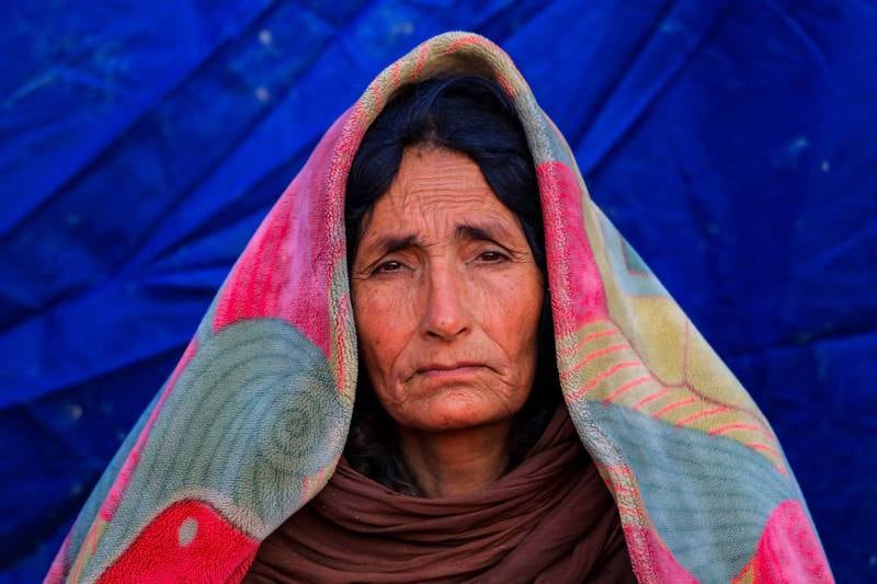 A woman sits outside the temporary shelter after the devastating earthquake in Paktia province, Afghanistan.  Authorities say the death toll is likely to rise. EPA 