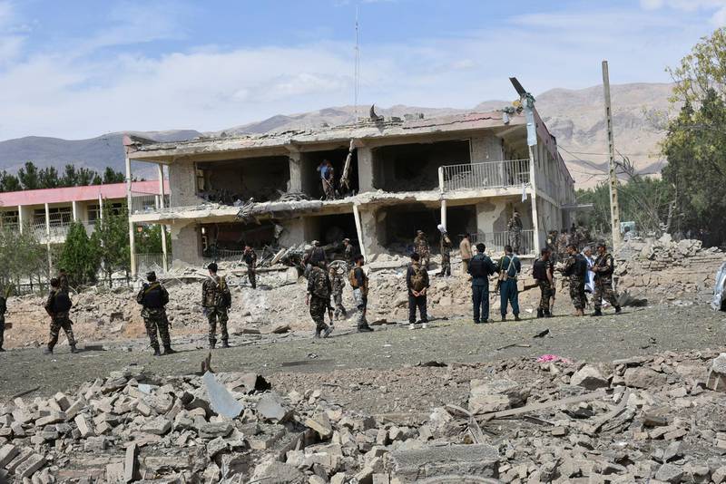 Afghan security personnel inspect the site of a bomb blast on an intelligence compound in Aybak, the capital of the Samangan province in northern Afghanistan. AP