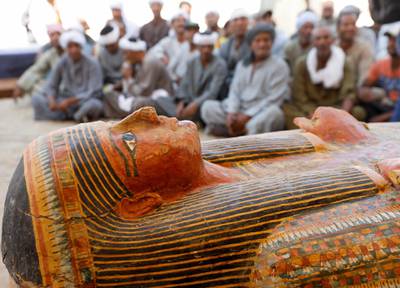 Excavators sit behind painted ancient coffins at Al-Asasif necropolis, unveiled by Egyptian antiquities officials in the Valley of the Kings in Luxor, Egypt. Reuters