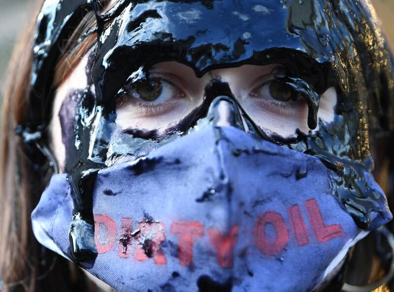 An Extinction Rebellion protester stands outside Selfridges department store on Oxford Street to demonstrate against the use of oil in fashion. EPA
