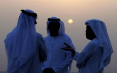 Men gather trying to sight the new crescent moon in Al Ain.  EPA
