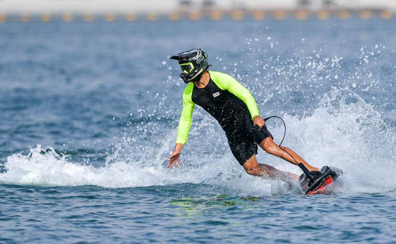 The rider of a jet-powered surfboard wows onlookers off Kite Beach.