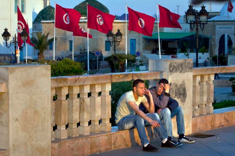 Young men hang out near the National Monument at Place de la Kasbah, as they talk and wach the passerbyes by on monday evening, April 18, 2011, in Tunis, the capital of Tunisia. The high unemployment, especially amongst the young, which in part sparked the country's January revolution, is only becoming more aparent as Tunisia enjoys its first few months of political freedom and stands at the beginning of its economic responsibility. (Silvia Razgova/The National)