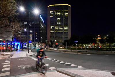 Office lights of the Lombardy region headquarters, the Pirelli Tower (Il Pirellone) in Milan, reading the Italian words 'State a Casa' (Stay home) during the country's lockdown. AFP