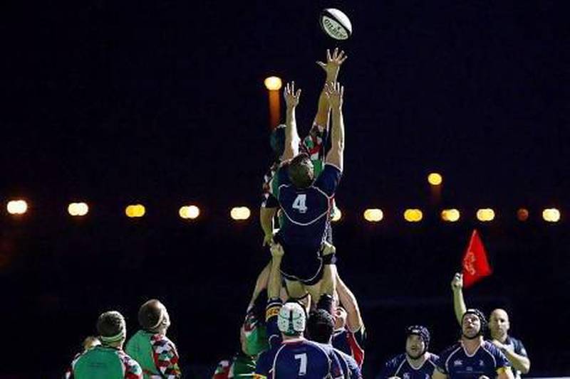 Jebel Ali Dragons, in blue, took over the top spot in the UAE's rugby echelon from Abu Dhabi Harlequins, in green, last season. With the national team's struggles, questions abound about pursuing Japan's model of corporate rugby as opposed to club rugby.