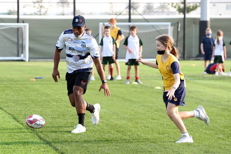 Former Fiji captain Osea Kolinisau and his Speranza 22 teammates lead a training session for young rugby players at Royal Grammar School Guildford Dubai, ahead of the Dubai Sevens tournament. All images: Pawan Singh / The National