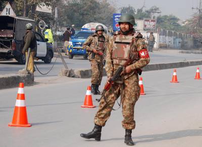 Pakistani security forces take up positions on a road leading to the Army Public School that is under attack by Taliban gunmen in Peshawar. Taliban gunmen in Pakistan took hundreds of students and teachers hostage on Tuesday in a school in the northwestern city of Peshawar, military officials said.  Khuram Parvez / Reuters