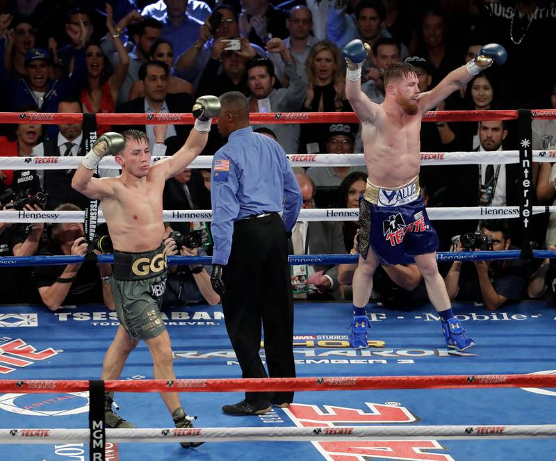 Saul 'Canelo' Alvarez, right, and Gennady Golovkin celebrate following a middleweight title fight. Isaac Brekken / AP Photo