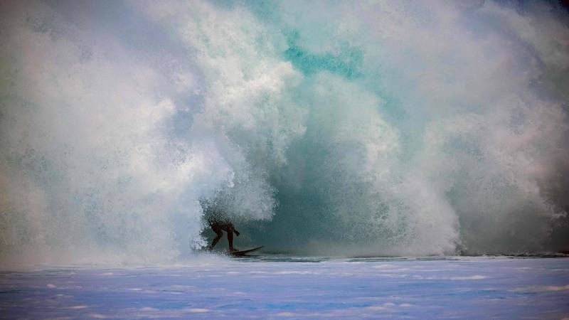 A surfer rides a wave at Pipeline on the north shore of Oahu, Hawaii, on Sunday, February 14. AFP