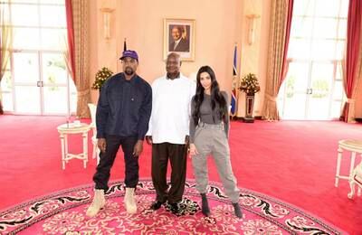 In this photo taken Monday, Oct. 15, 2018, released by Presidential Press Unit, Kanye West, left, and his wife reality TV star Kim Kardashian West, right, pose for a photo with Uganda's President Yoweri Museveni, at State House in Entebbe, Uganda.  Museveni said he and West held "fruitful discussions" about promoting tourism and arts in the East African nation in which the rapper is said to be recording music in a tent. (Presidential Press Unit via AP)