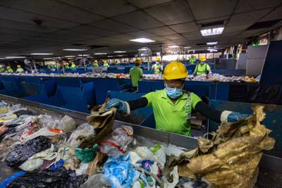 Workers sort solid waste material at the Bee'ah waste management complex in Sharjah. Christopher Pike / Bloomberg