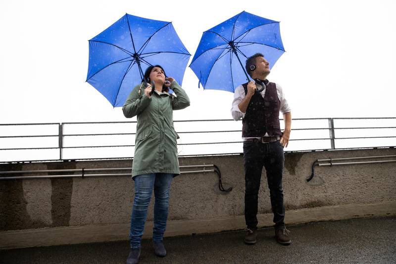 Robert Habeck and Annalena Baerbock, the leaders of the Germany's Green Party stand with umbrellas during a visit the energy bunker in Hamburg-Wilhelmsburg in July 2020. AP Photo