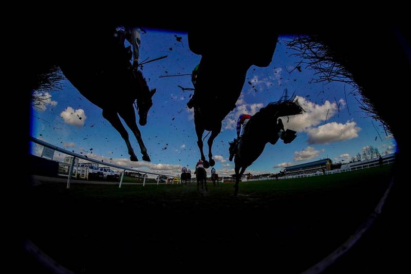 Runners clear a fence during the Watch On Racing TV Novices' Handicap Chase at Warwick Racecourse in England on Friday, February 26. Getty