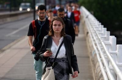 Commuters cross Waterloo Bridge in London. The British Retail Consortium said spending in store chains rose by 6.9 per cent in annual terms in December, but this was a long way off consumer price inflation, which hit 10.7 per cent in November. Reuters