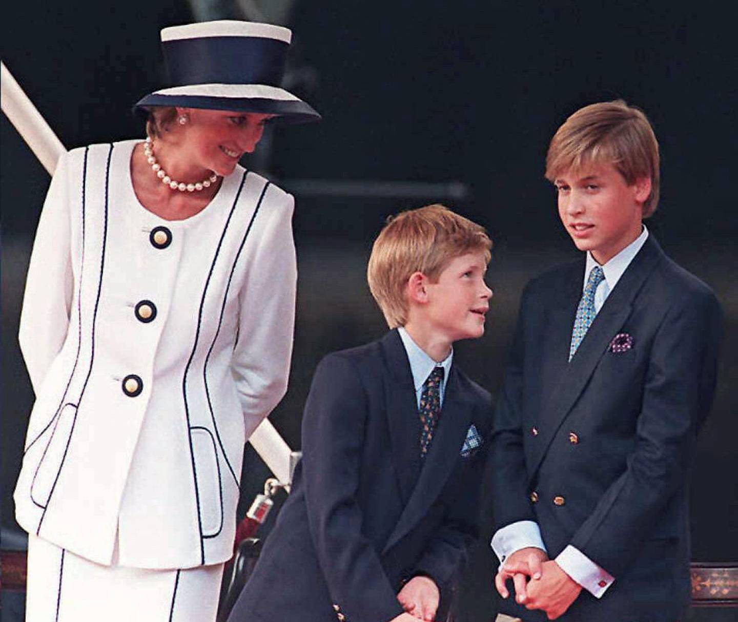 (FILES) This file photo taken on August 19, 1995 shows Britain's Diana, Princess of Wales (L), and her sons Prince Harry, (C) and Prince William, as they gather for the commemorations of VJ Day in London.
Two decades on from the death of princess Diana, her sons Princes William and Harry are working to keep her legacy alive with unusually emotional tributes after years of official silence. William was 15 and Harry 12 when Diana died in a car crash in Paris on August 31, 1997. / AFP PHOTO / JOHNNY EGGITT