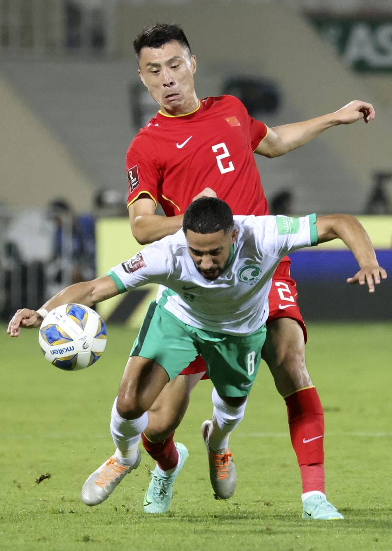 China's defender Zheng Zheng pressures Saudi Arabia midfielder Hattan Bahebri. AFP