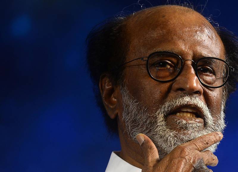 Indian film actor Rajinikanth gestures as he announces his entry in politics during an interaction session with fans in Chennai on December 31, 2017.
Rajinikanth, the wildly popular Indian cinema icon who inspires almost god-like adulation in some parts of the country, announced his entry into politics on December 31. / AFP PHOTO / ARUN SANKAR