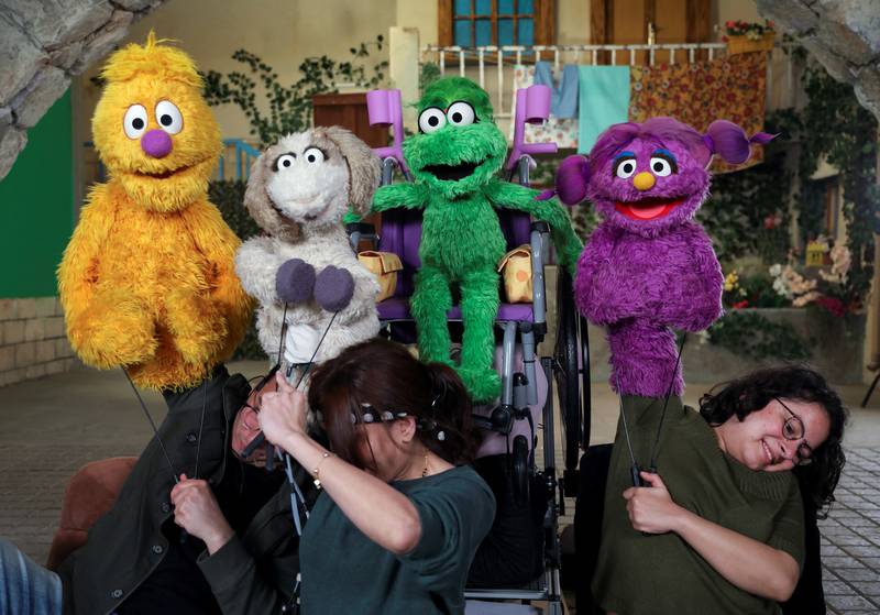 Puppeteers and puppets, including Ameera, the new muppet character who uses a purple wheelchair or crutches to get around because of a spinal cord injury, during the filming of the children's TV show 'Ahlan Simsim', in Amman, Jordan. All photos: Reuters