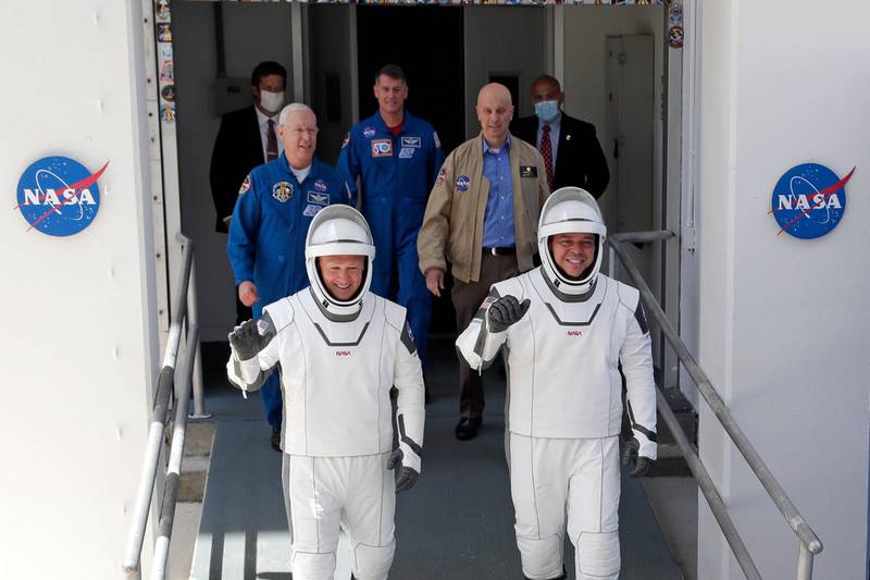 Nasa astronauts Douglas Hurley, left, and Robert Behnken walk out of the Neil A Armstrong Operations and Checkout Building. AP