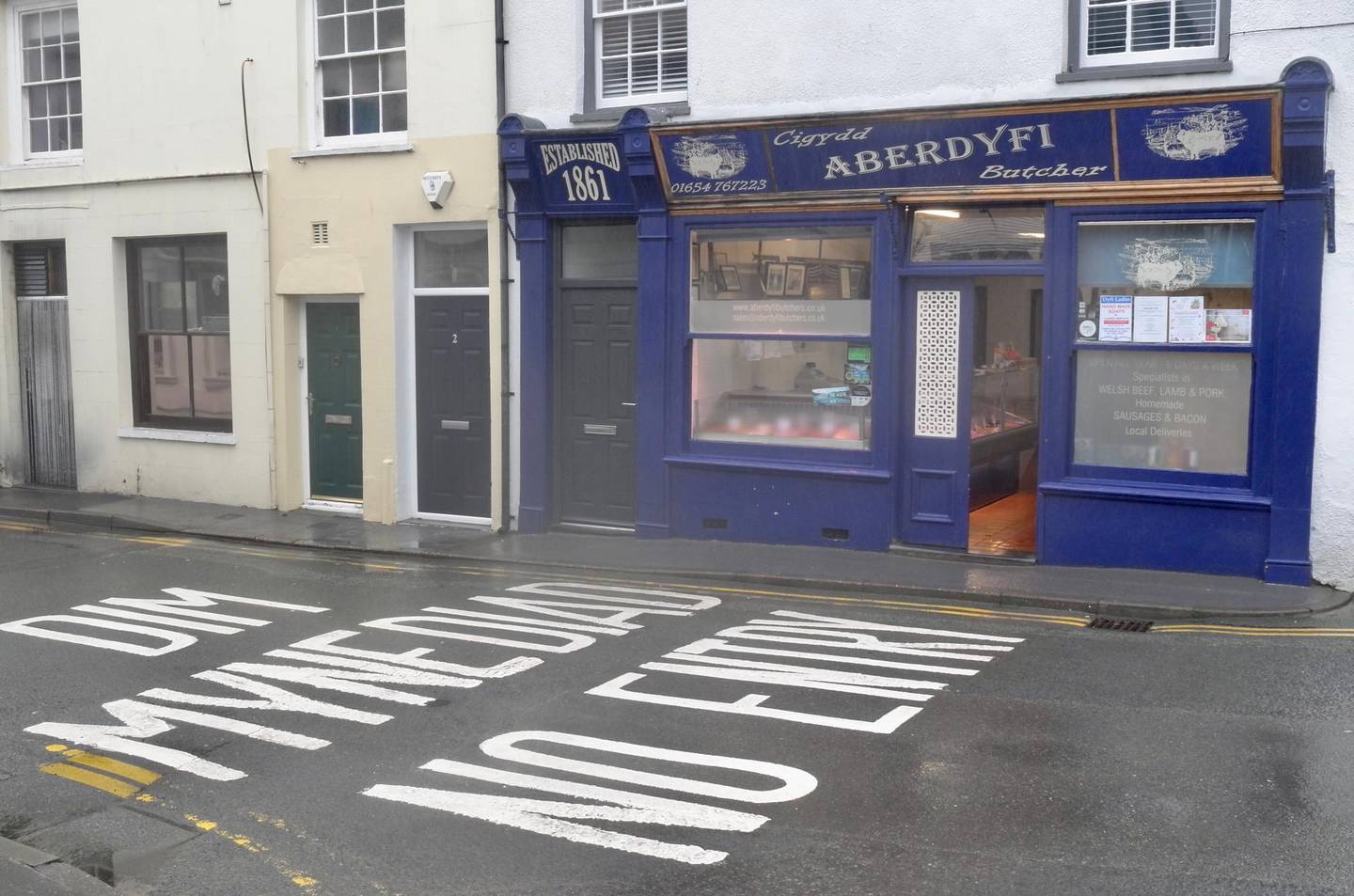 Aberdovey's butcher with Welsh road sign. James Langton for The National
