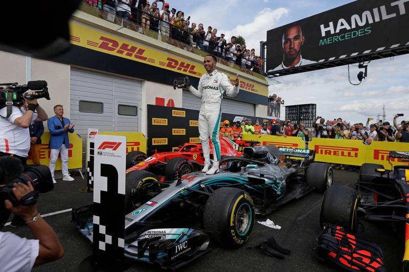 Mercedes driver Lewis Hamilton of Britain celebrates while standing on his car after winning the French Formula One Grand Prix at the Paul Ricard racetrack, in Le Castellet, southern France, Sunday, June 24, 2018. (AP Photo/Claude Paris)