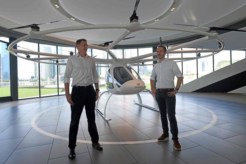Florian Reuter (R), CEO of Volocopter and Duncan Walker (L), managing director of Skyports stands in front of the Volocopter unmanned air taxi transport during a press conference ahead of the 26th Intelligent Transport Systems World Congress (ITSWC) in Singapore.  AFP