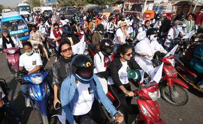 Women ride bikes as they participate in the Women Leadership Rally in Karachi, Pakistan. EPA