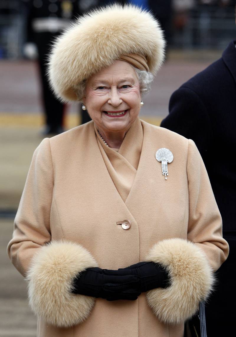 Queen Elizabeth II, wearing peach, arrives to unveil a memorial to the Queen Mother on The Mall on February 24, 2009, in London. Getty Images