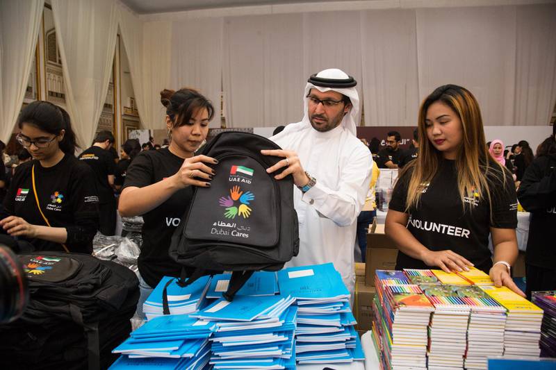Tariq Al Gurg, CEO of Dubai Cares, helps volunteers prepare packs of school essentials for children affected by the war in Syria