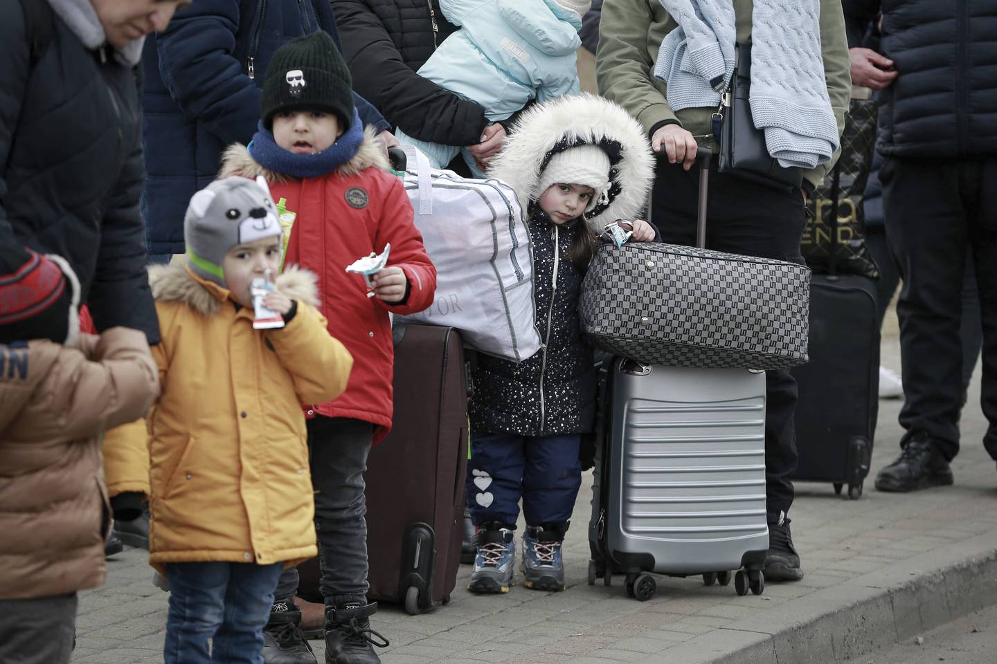 Children fleeing the war wait for a bus to take them to Poland. AP Photo / Visar Kryeziu