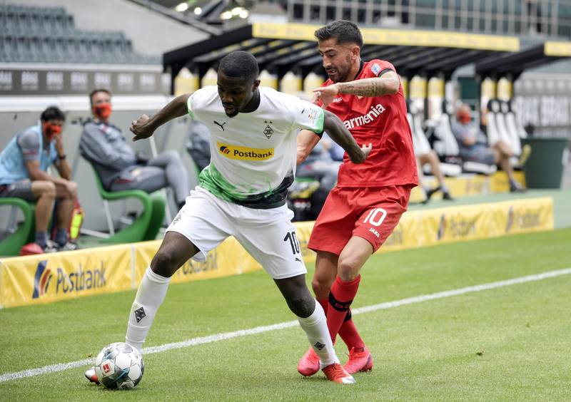 Marcus Thuram of Borussia Moenchengladbach is challenged by Kerem Demirbay of Bayer 04 Leverkusen. Getty Images