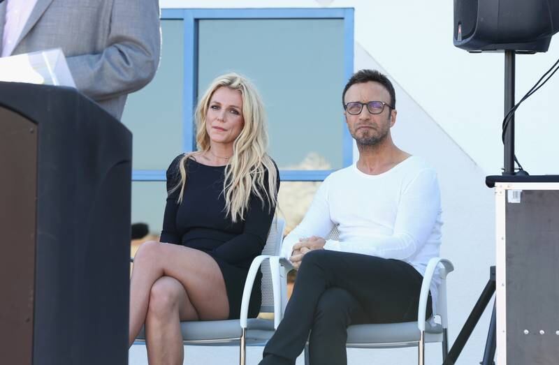 Britney Spears and talent manager Larry Rudolph listen to Clark County Commissioner Steve Sisolak's speech during the grand opening of the Nevada Childhood Cancer Foundation Britney Spears Campus in Las Vegas, Nevada. Getty Images