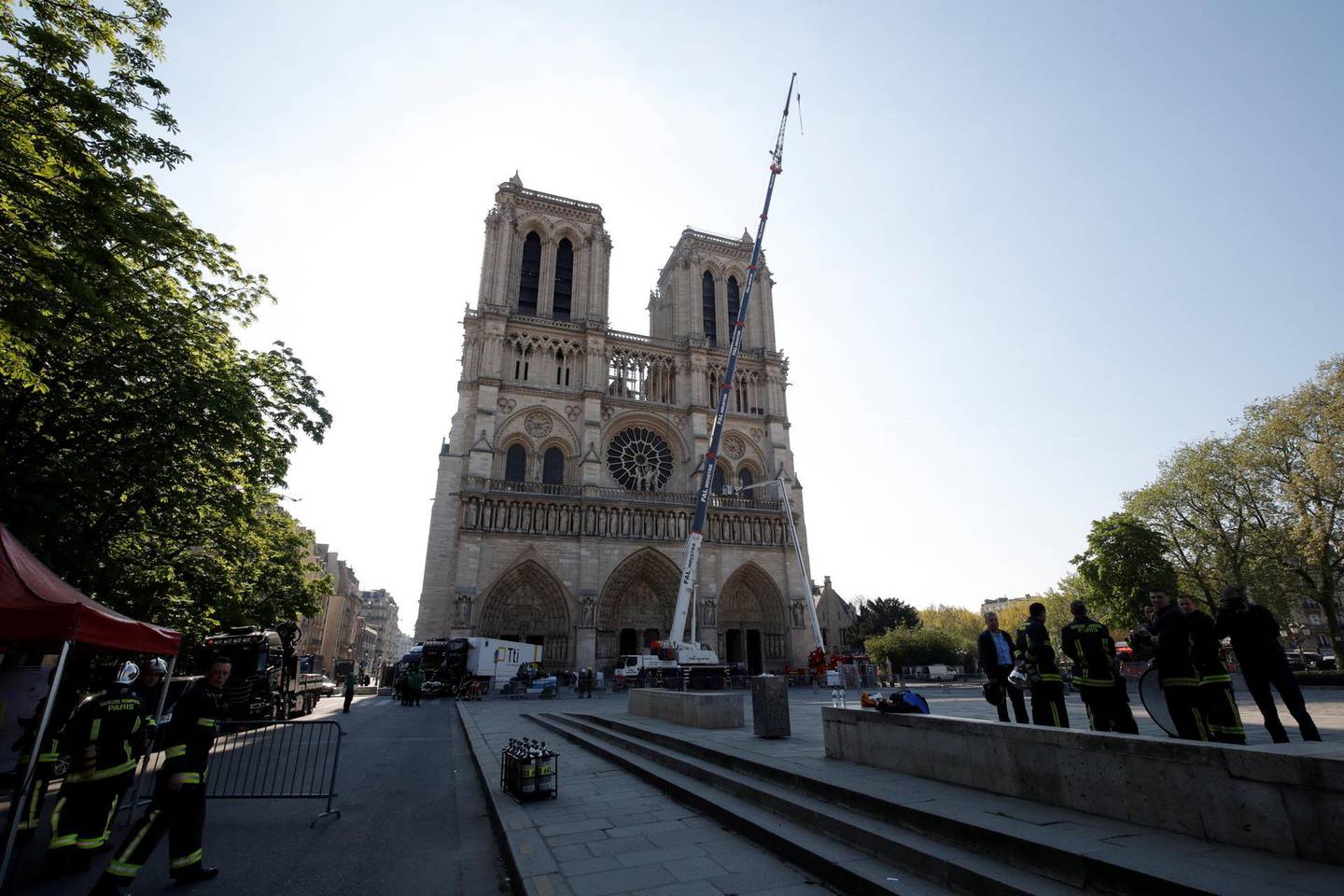epa07515572 A view shows a crane working on a facade at the Notre-Dame Cathedral, days after a massive fire devastated large parts of the gothic structure in Paris, France, 19 April 2019. A fire ravaged Notre Dame of Paris Cathedral, one of the most visited monuments of the French capital, on 15 April.  EPA/PHILIPPE WOJAZER / POOL  MAXPPP OUT