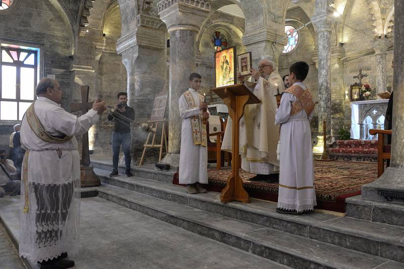 Priests lead mass at the Syriac Catholic Church of Mar Tuma. As part of the restoration, its marble floor has been dismantled and completely redone.  