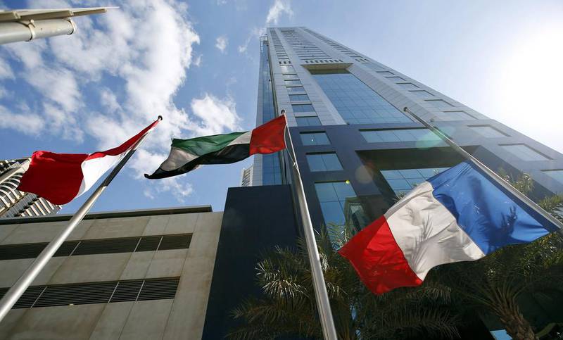 The French national flag flies at half-mast beside the flag of the UAE, in front of the Habtoor Business Tower location of the French Consulate in Dubai. EPA