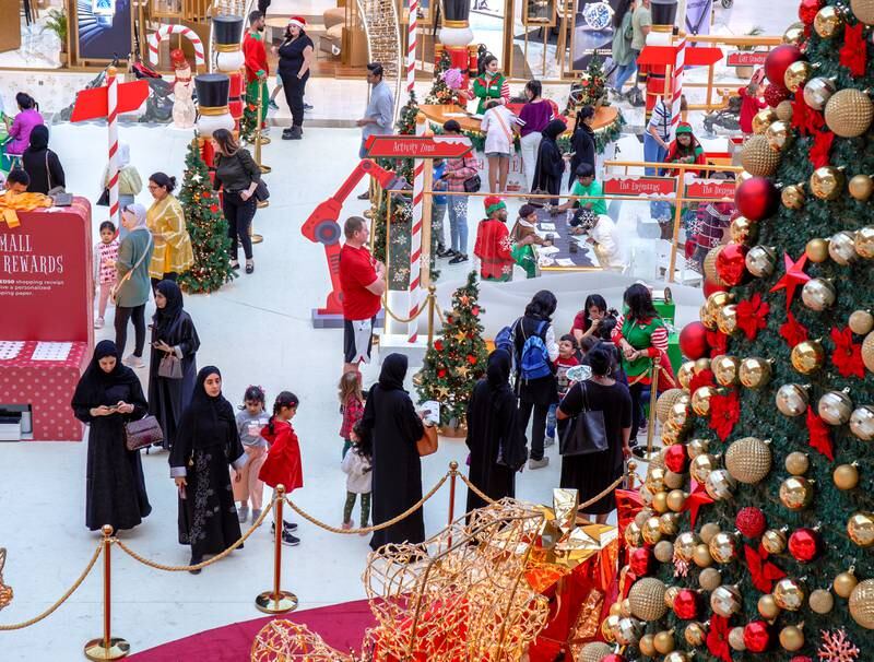 Visitors take in the festive sights at Town Square, Yas Mall. Victor Besa / The National