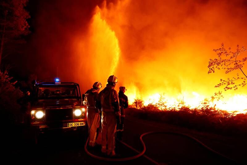 Firefighters work to contain a tactical fire in Louchats as fires spread in the Gironde region of France on Sunday. Reuters